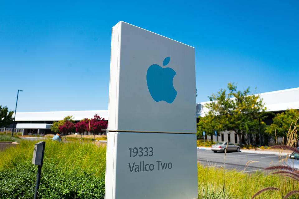 Low-angle view of blue colored sign with logo and buildings near the headquarters of Apple Computers in the Silicon Valley, Cupertino, California, August 26, 2018. (Photo by Smith Collection/Gado/Getty Images)