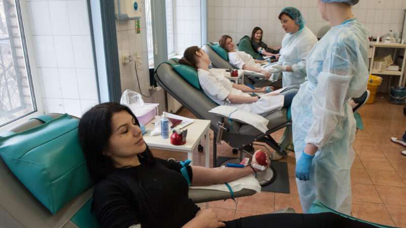 Woman is giving blood in a blood transfusion clinic