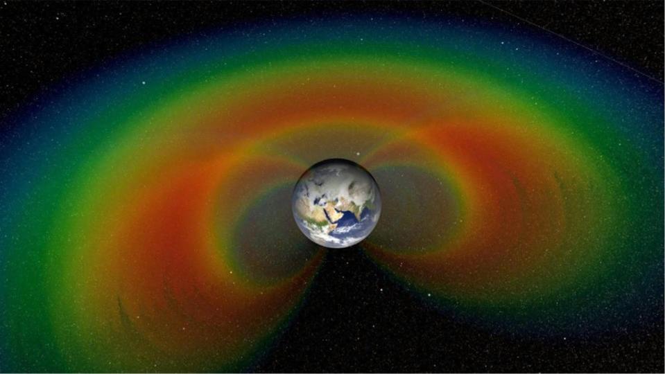 illustration of the Earth with red and green radiation bubbles, the so-called Van Allen belts