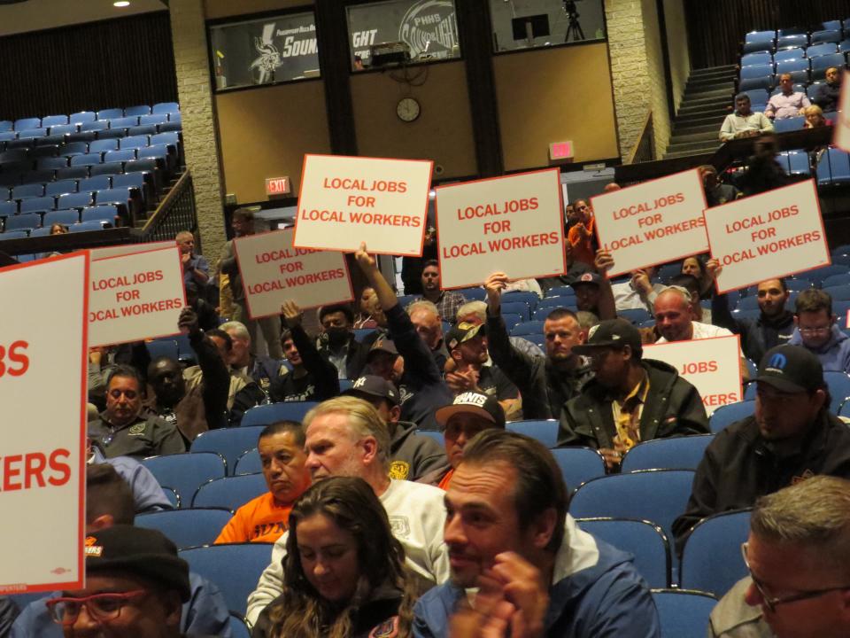 Union workers applaud the passage of a project labor agreement ordinance at a Parsippany Council meeting  Oct. 19, 2022 at Parsippany Hills High School.