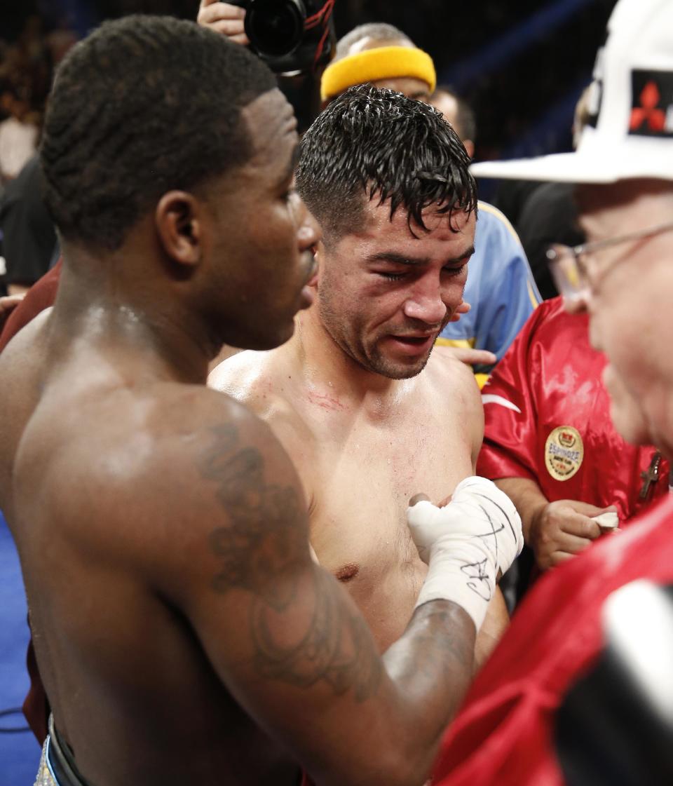 Adrien Broner, left, from Cincinnati, Ohio, talks with Carlos Molina, from Norwalk, Calif., after winning their WBA super lightweight title boxing fight by unanimous decision Saturday, May 3, 2014, in Las Vegas. (AP Photo/Eric Jamison)