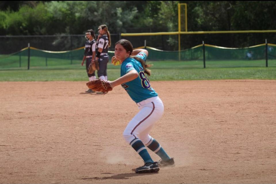 Kaylee Goodpaster makes a throw during a travel ball game this summer.