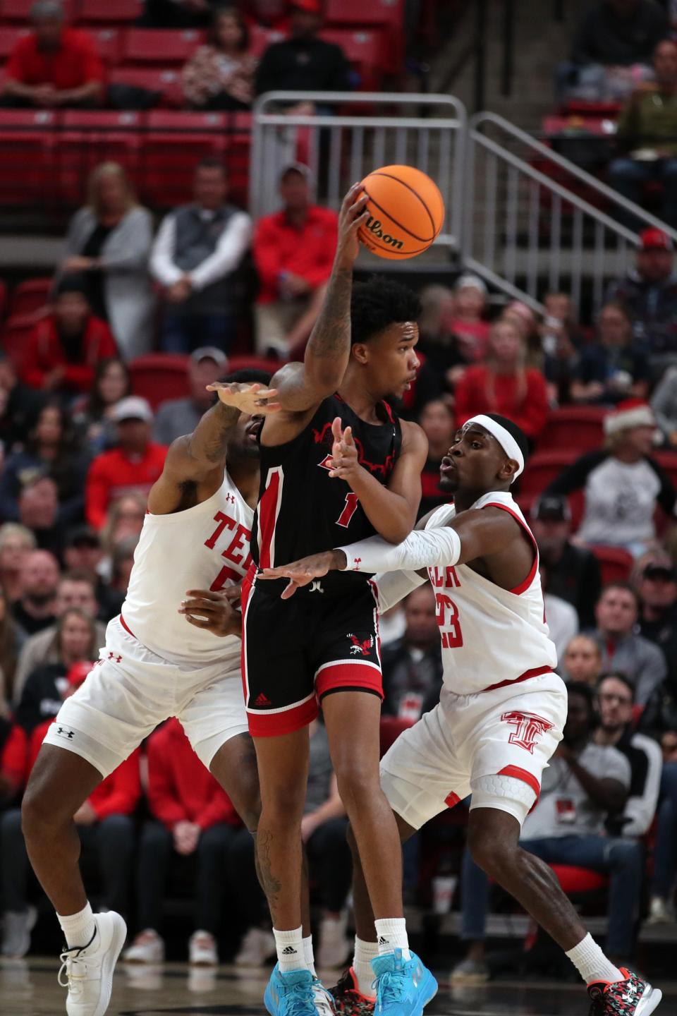 Dec 13, 2022; Lubbock, Texas, USA; Eastern Washington Eagles guard Tyreese Davis (1) passes the ball in front of Texas Tech Red Raiders guard DeÕVion Harmon (23) and forward KJ Allen (5) in the first half at United Supermarkets Arena. Mandatory Credit: Michael C. Johnson-USA TODAY Sports ORG XMIT: IMAGN-500888 ORIG FILE ID:  20221213_jcd_aj7_0144.JPG