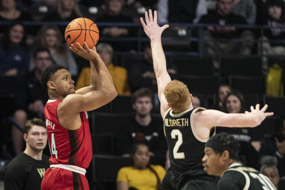 North Carolina State guard Casey Morsell (14) shoots over Wake Forest guard Cameron Hildreth (2) in the first half of an NCAA college basketball game on Saturday, Jan. 28, 2023, at Joel Coliseum in Winston-Salem, N.C. (Allison Lee Isley/The Winston-Salem Journal via AP)