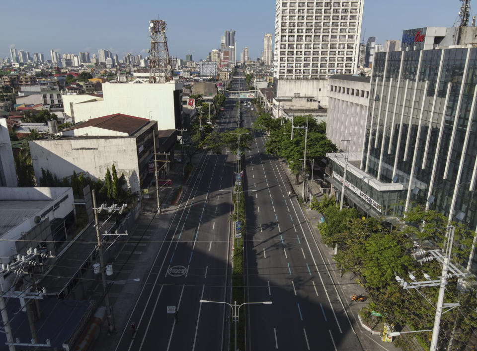 An almost empty Espana boulevard as the government implements a strict lockdown to prevent the spread of the coronavirus on Good Friday, April 2, 2021 in Manila, Philippines. Filipinos marked Jesus Christ's crucifixion Friday in one of the most solemn holidays in Asia's largest Catholic nation which combined with a weeklong coronavirus lockdown to empty Manila's streets of crowds and heavy traffic jams. Major highways and roads were eerily quiet on Good Friday and churches were deserted too after religious gatherings were prohibited in metropolitan Manila and four outlying provinces. (AP Photo/Aaron Favila)