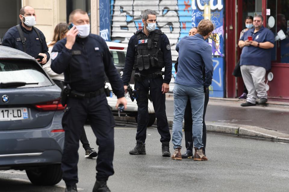 A woman is comforted after several people were injured near the former offices of the French satirical magazine Charlie Hebdo following an attack by a man wielding a knife in the capital Paris on September 25, 2020. - Four people were injured, two seriously, in a knife attack in Paris on September 25, 2020, near the former offices of French satirical magazine Charlie Hebdo, a source close to the investigation told AFP. Two of the victims were in a critical condition, the Paris police department said, adding two suspects were on the run. The stabbing came as a trial was underway in the capital for alleged accomplices of the authors of the January 2015 attack on the Charlie Hebdo weekly that claimed 12 lives. (Photo by Alain JOCARD / AFP) (Photo by ALAIN JOCARD/AFP via Getty Images)