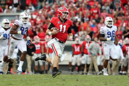 Oct 27, 2018; Jacksonville, FL, USA; Georgia Bulldogs quarterback Jake Fromm (11) runs the ball against the Florida Gators during the second half at TIAA Bank Field. Mandatory Credit: Kim Klement-USA TODAY Sports