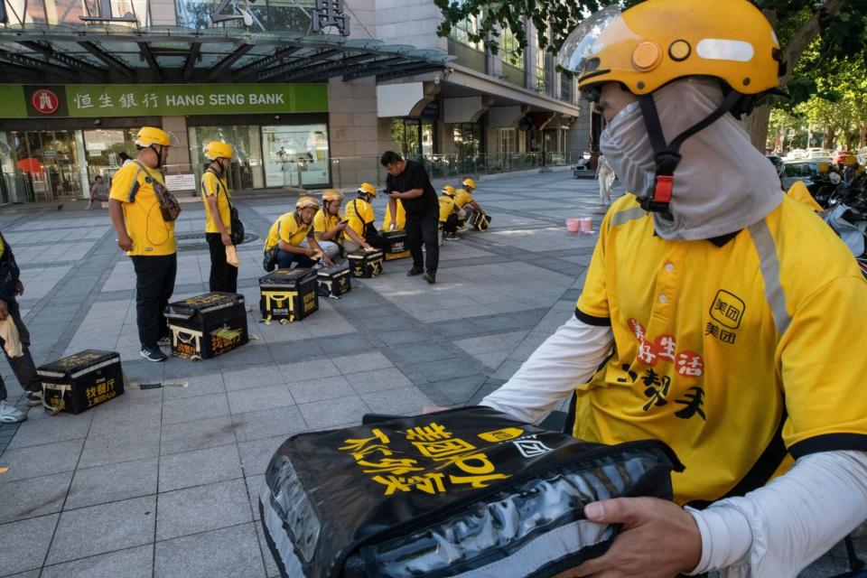 Food delivery couriers for Meituan in Beijing, China. Meituan operates in more than 2,800 cities and counties in the world’s second-largest economy.