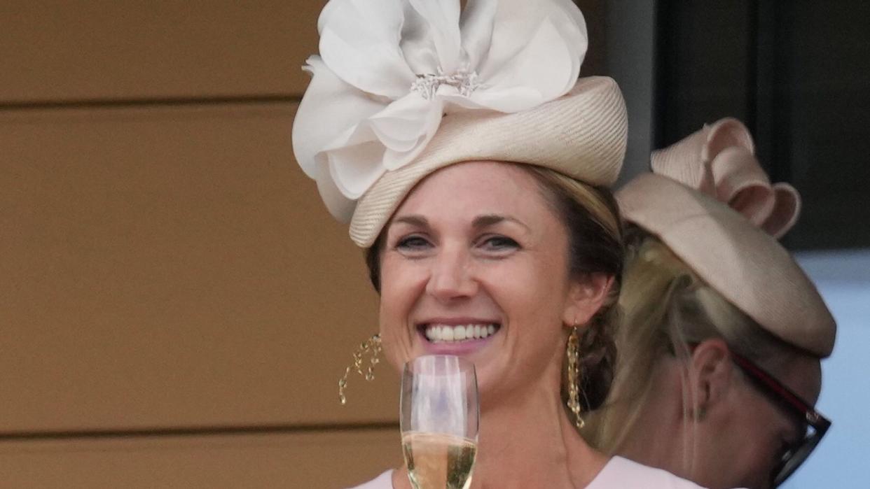 Harriet Sperling drinking champagne in pink