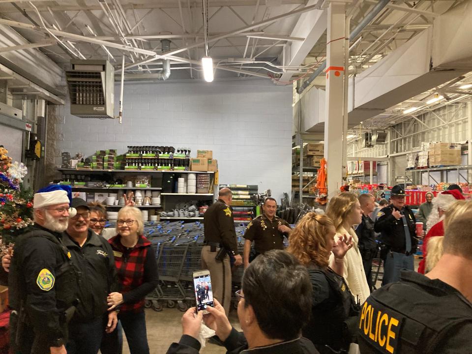 Police and other heroes gather for the Heroes and Helpers event to buy and distribute toys to families in need this Christmas season.