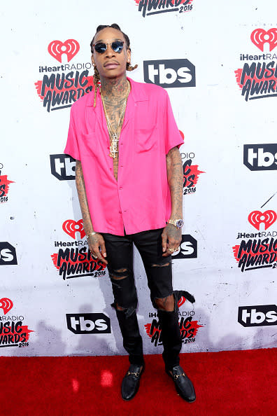 Wiz Khalifa in a pink blouse and Gucci loafers. 