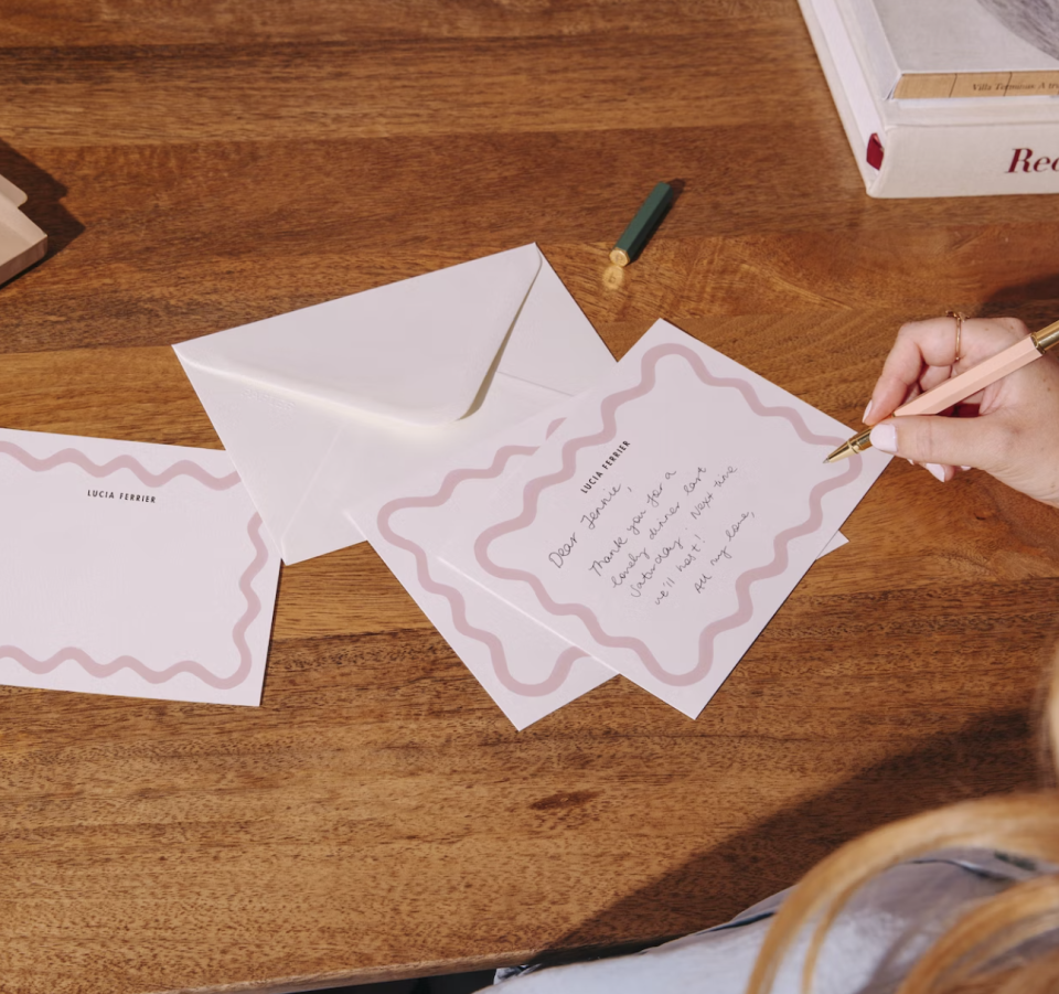 person writing with pen on Custom Scallop Trim Notecard Set (Photo via Papier)