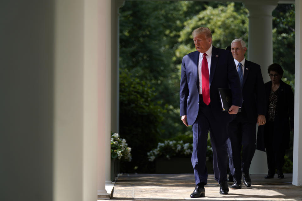 President Donald Trump arrives to speak at a news conference in the Rose Garden of the White House, Friday, June 5, 2020, in Washington. Vice President Mike Pence and Small Business Administration administrator Jovita Carranza are at right. (AP Photo/Evan Vucci)