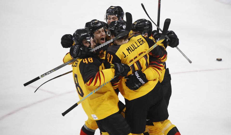 FILE- Jonas Muller (41), of Germany, celebrates with teammates after scoring a goal during the third period of the men's gold medal hockey game against the Olympic athletes from Russia at the 2018 Winter Olympics, Sunday, Feb. 25, 2018, in Gangneung, South Korea. Four years after an improbable run to the Olympic final and that ended with a silver medal, Germany is back at the 2022 Beijing Olympics without NHL players looking to duplicate that effort. (AP Photo/Jae C. Hong, File)