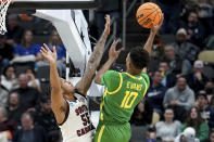 Oregon's Kwame Evans Jr. (10) shoots over South Carolina's Ta'Lon Cooper (55) during the first half of a first-round college basketball game in the NCAA Tournament, Thursday, March 21, 2024, in Pittsburgh. (AP Photo/Matt Freed)