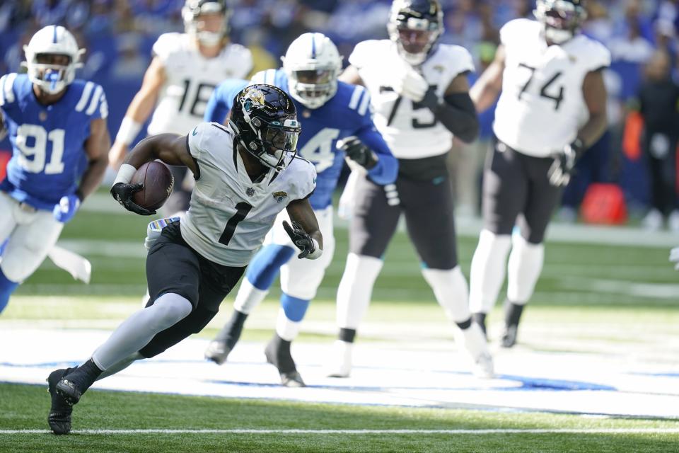 Jacksonville Jaguars' Travis Etienne Jr. (1) runs during the first half of an NFL football game against the Indianapolis Colts, Sunday, Oct. 16, 2022, in Indianapolis.(AP Photo/Michael Conroy)