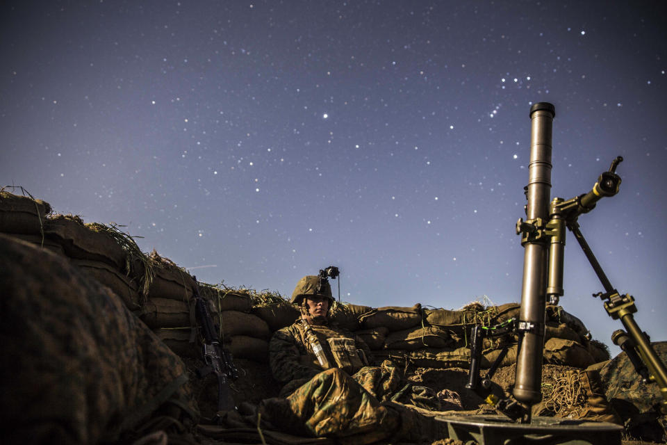 Lance Cpl. Griffin Forrester stands his post in his fighting hole during a beach raid aboard Camp Pendleton, California, March 6, 2015.