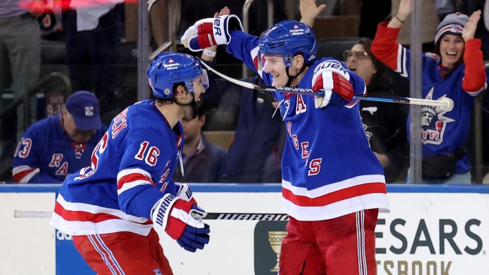 Mar 26, 2024; New York, New York, USA; New York Rangers defenseman Adam Fox (23) celebrates his game winning goal against the Philadelphia Flyers with center Vincent Trocheck (16) during overtime at Madison Square Garden.