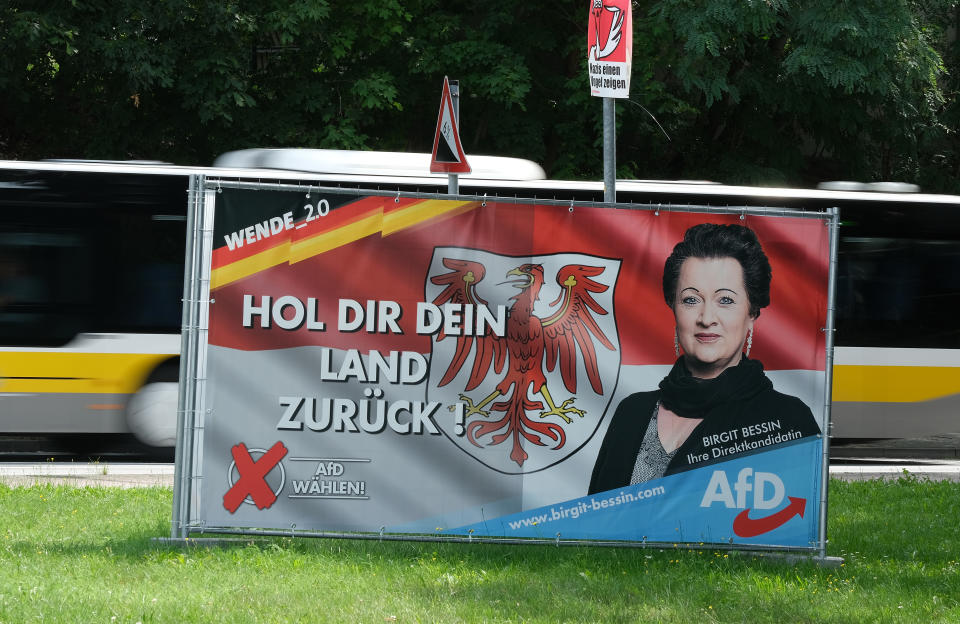 JUTERBOG, GERMANY - AUGUST 09: A bus drives past an election campaign billboard of the right-wing Alternative for Germany (AfD) that shows the Brandenburg state flag and reads: "Take your country back!" ahead of state elections in Brandenburg state on August 09, 2019 in Juterbog, Germany. Brandenburg and Saxony, both states in eastern Germany, are due to hold elections on September 1, and in both the AfD is a strong contender for first place. (Photo by Sean Gallup/Getty Images)