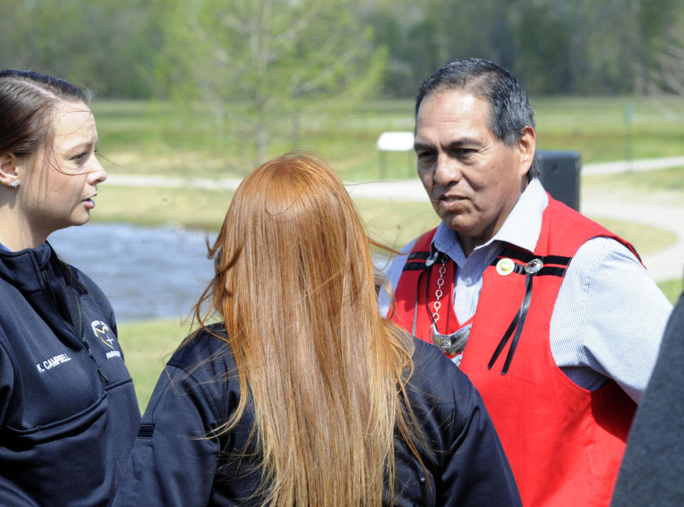 FILE - Muscogee (Creek) Nation Principal Chief David Hill, right, speaks with local paramedics during the opening of a two-day festival in Oxford, Ala., April 8, 2022. On Wednesday, June 28, a federal court ruled that a speeding ticket issued by the City of Tulsa to a Native American man cannot be enforced because the city is located within an Indian reservation. “Citizens of Tulsa, if your city government cannot enforce something as simple as a traffic violation, there will be no rule of law in eastern Oklahoma,” Oklahoma Gov. Kevin Stitt said in a statement. Stitt's reaction to the ruling drew harsh condemnation from Hill. (AP Photo/Jay Reeves, File)