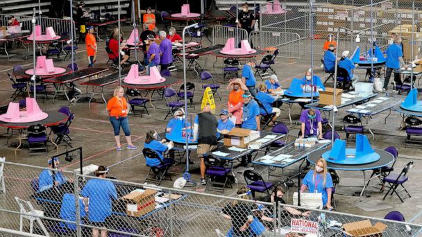 PHOTO: In this May 6, 2021, file photo, Maricopa County ballots cast in the 2020 general election are examined and recounted by contractors working for Florida-based company, Cyber Ninjas, at Veterans Memorial Coliseum in Phoenix. (Matt York/AP, FILE)