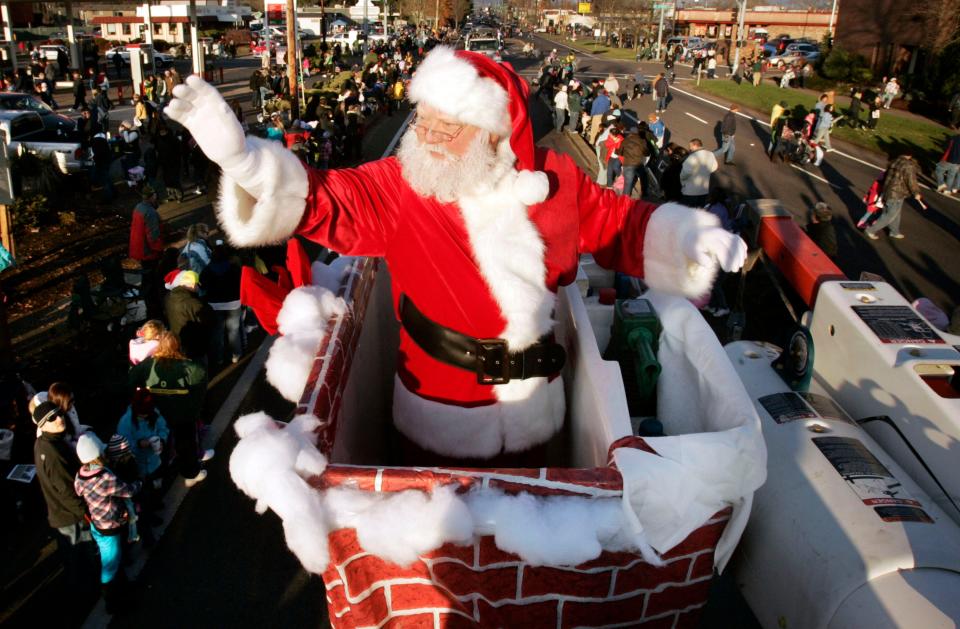 Santa Claus waves to the crowd as he rides along the Springfield Christmas Parade route in a Springfield Utility Board bucket truck before the pandemic.