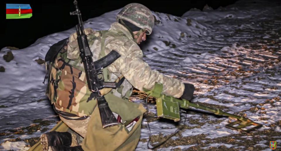 This photo taken from a video released by Azerbaijan's Defense Ministry on Wednesday, Nov. 25, 2020, shows an Azerbaijan's army de-miner during mine clearance in Kalbajar region of Azerbaijan. The Kalbajar district bordering Armenia, which houses one of the two roads linking Nagorno-Karabakh and the neighbouring country and has strategic significance for Armenians and Azeris, is due to be handed over to Azerbaijan according to a Russia-brokered cease-fire agreement between two countries in the long-running conflict over the separatist territory. (Azerbaijan's Defense Ministry via AP)