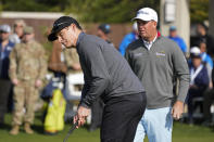 Steve Young, left, and Tom Hoge compete in the putting challenge event of the AT&T Pebble Beach Pro-Am golf tournament in Pebble Beach, Calif., Wednesday, Feb. 1, 2023. (AP Photo/Eric Risberg)