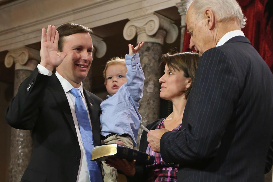 Rider Murphy raises his hand just like his father, U.S. Sen. Chris Murphy (D-CT) (L) as he participates in a reenacted swearing-in with his wife Catherine Murphy and U.S. Vice President Joe Biden in the Old Senate Chamber at the U.S. Capitol January 3, 2013