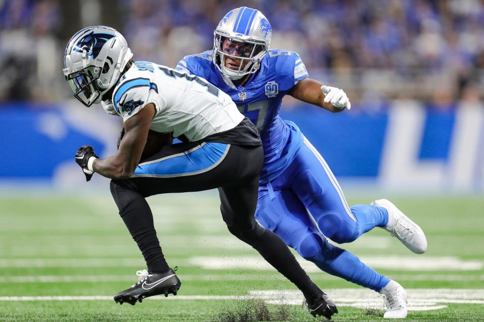 Lions linebacker Anthony Pittman tackles Panthers punt return Ihmir Smith-Marsette during the second half of the Lions' 42-24 win on Sunday, Oct. 8, 2023, at Ford Field.