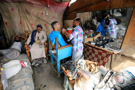 Ahmad Ali Ibrahim, 34, works in a barber shop in Hodeidah, Yemen March 25, 2019. REUTERS/Abduljabbar Zeyad