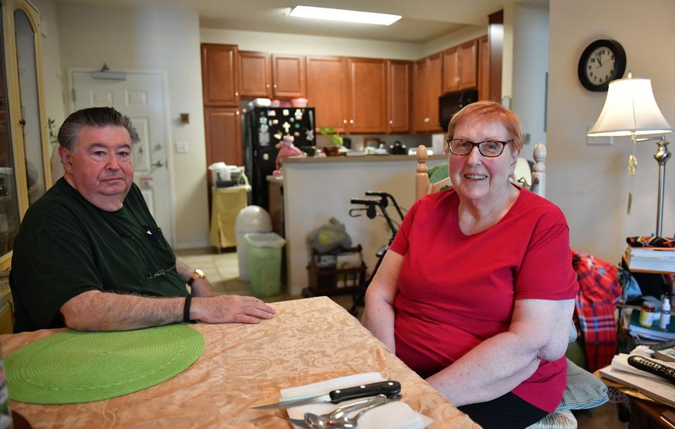 Art and Judith McLaughlin sit at the dining room table in their modest two-bedroom apartment.