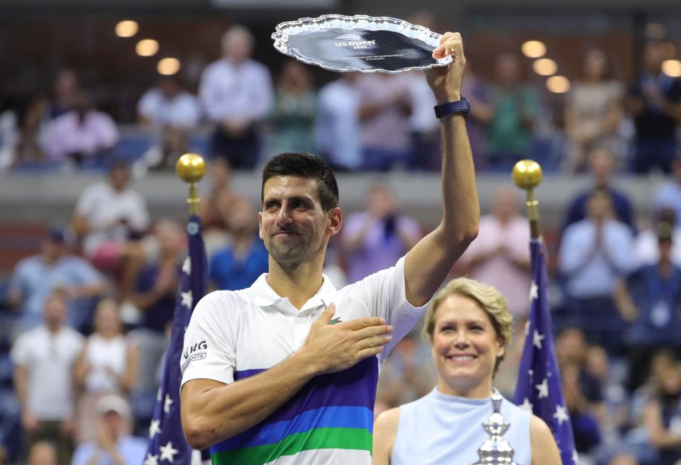 Novak Djokovic (pictured) holds his trophy after losing the 2021 US Open.