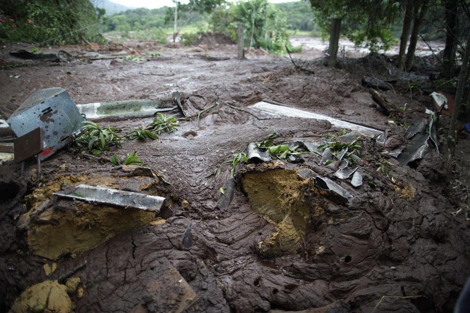 The mud covers the backyard of a house after a dam collapse near Brumadinho, Brazil, Saturday, Jan. 26, 2019. Rescuers in helicopters on Saturday searched for survivors while firefighters dug through mud in a huge area in southeastern Brazil buried by the collapse of a dam holding back mine waste, with at least nine people dead and up to 300 missing. (AP Photo/Leo Correa)