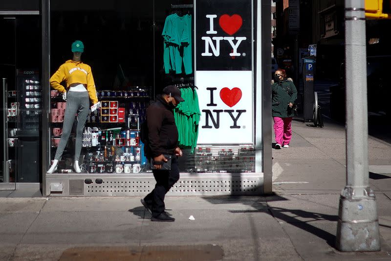 People walk in nearly deserted Times Square during the outbreak of the coronavirus disease (COVID-19) in New York