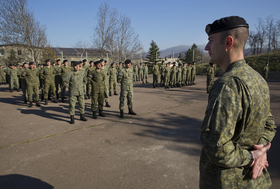 In this photo taken on Thursday, March 22, 2018, members of Kosovo Security Force (KSF) line up for a flag raising ceremony inside the barracks in the southern part of the ethnically divided town of Mitrovica. Kosovo is moving to build itself a regular army, angering neighboring Serbia enough to talk of military intervention _ a seemingly empty threat. (AP Photo/Visar Kryeziu)