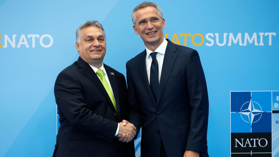 Hungarian Prime Minister Viktor Orban (L) is welcomed by NATO Secretary General Jens Stoltenberg (R) as he arrives for a NATO summit at the alliance's headquarters in Brussels on July 11, 2018. - Francois Mori/AFP via Getty Images
