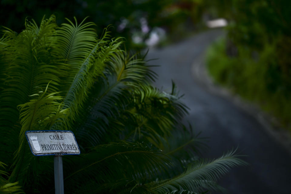 A small sign identifies Primitiva Torres street in the Cañabón neighborhood of Caguas, Puerto Rico, Wednesday, Sept. 30, 2020. The lack of standardized addresses is so widespread that the government recommends a home emergency plan include designating someone to go out to a main road to flag down emergency responders. (AP Photo/Carlos Giusti)