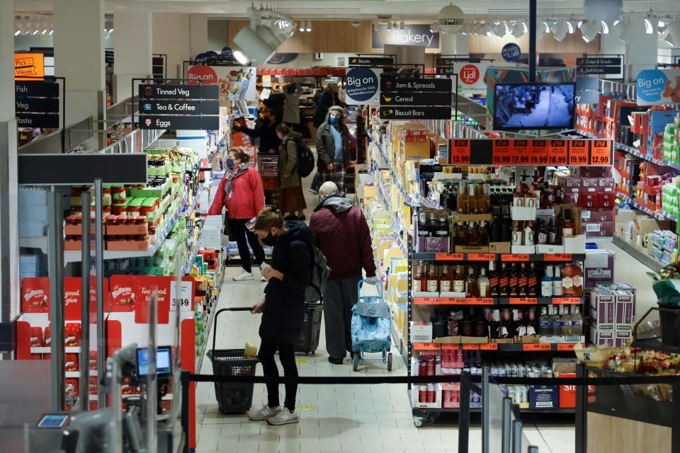 Shoppers browse for goods inside an Lidl supermarket in Walthamstow in north east London on December 22, 2020. - The British government said Tuesday it was considering tests for truckers as part of talks with French authorities to allow the resumption of freight traffic suspended due to a new strain of coronavirus. Britain was plunged into fresh crisis last week with the emergence of a fresh strain of the virus, which is believed to be up to 70 percent more transmissible than other forms. (Photo by Tolga Akmen / AFP) (Photo by TOLGA AKMEN/AFP via Getty Images)