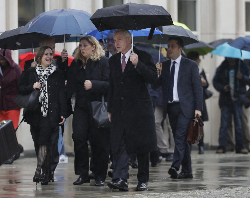 Richard Donoghue, center, the United States Attorney for the Eastern District of New York enter Brooklyn federal court, Tuesday, Nov. 13, 2018. Opening statements at the trial of the notorious Mexican drug lord Joaquin "El Chapo" Guzman are to begin Tuesday morning under tight security. The evidence will include the testimony of more than a dozen cooperating witnesses who prosecutors say are risking retribution by taking the stand. (AP Photo/Mark Lennihan)