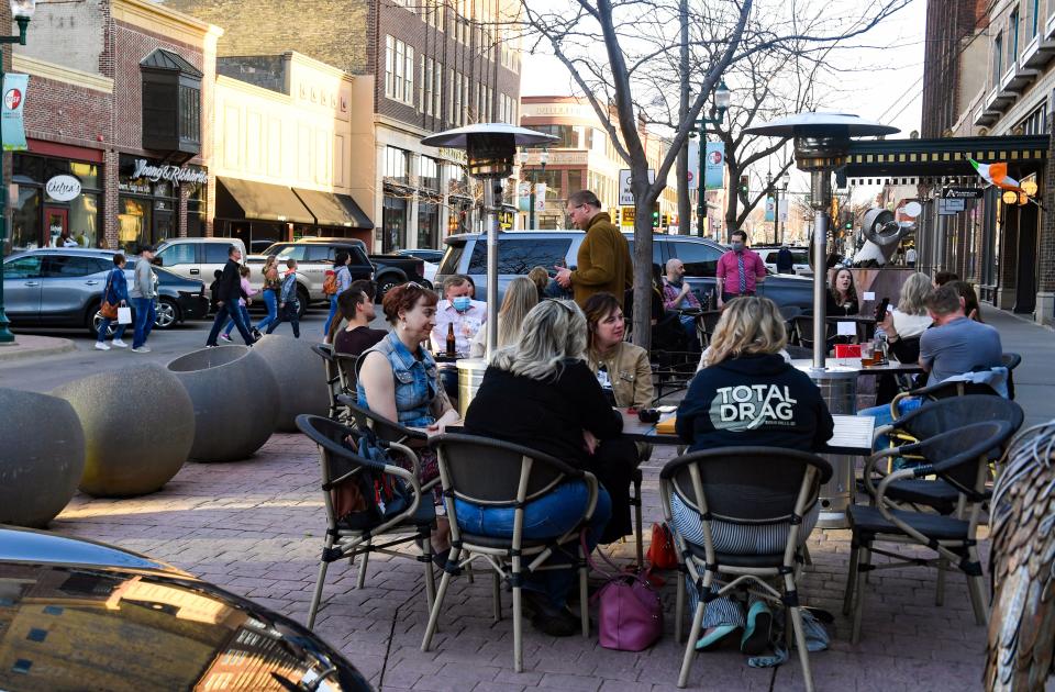 People drink and socialize on the patio on Friday, April 2, 2021 at the Carpenter Bar in Sioux Falls.