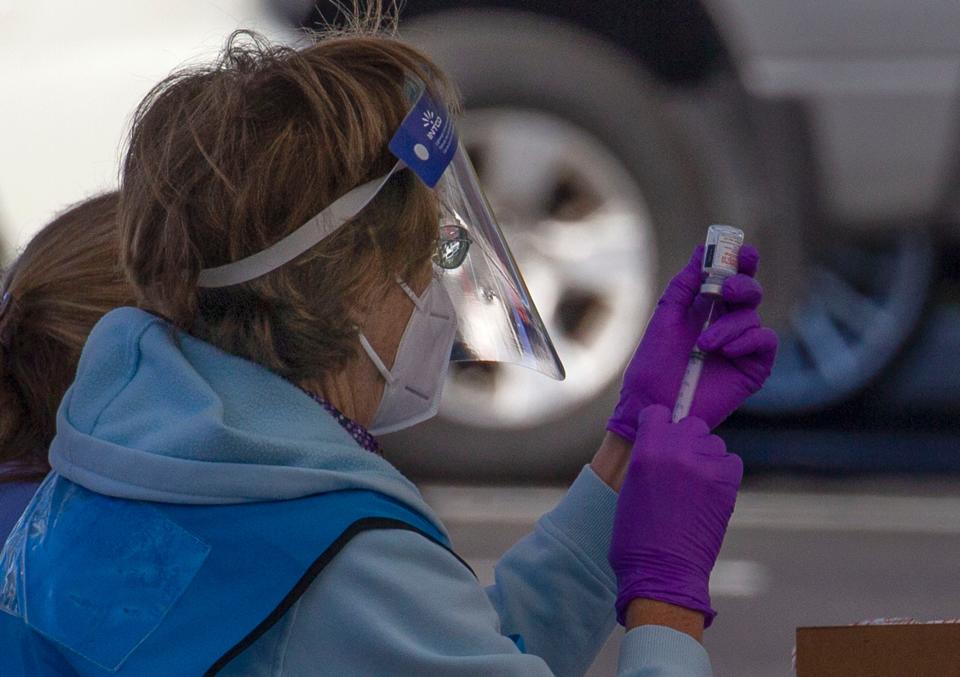 Selma Verse, R.N., with Medical Reserve Corps, prepares a dose of the Moderna COVID-19 vaccine for a patient scheduled for the 
COVID-19 drive-thru vaccine clinic at the Florida Department of Health Martin County office in Stuart on Monday, Jan. 4, 2021.  The clinic was for people ages 65 and older, health care workers, and adults of any age with serious underlying medical conditions who were at risk for severe illness with COVID-19.