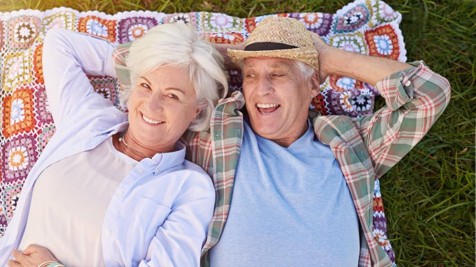 Portrait of a happy senior couple relaxing together on the lawnhttp://195.