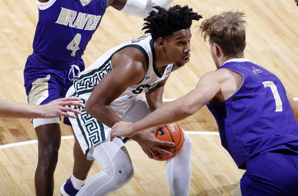 Michigan State's A.J. Hoggard, center, drives against Alcorn State's Alex Tsynkevich, right, and Roderick Jones (4) during the first half of an NCAA college basketball game, Sunday, Nov. 19, 2023, in East Lansing, Mich. (AP Photo/Al Goldis)