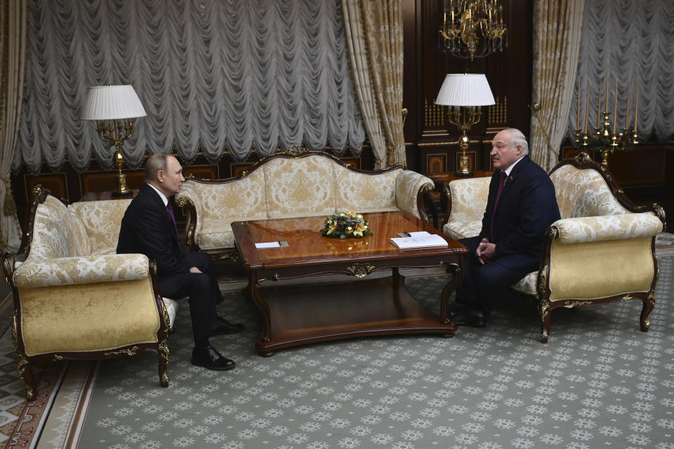 Russian President Vladimir Putin, left, and Belarusian President Alexander Lukashenko talk during their meeting in Minsk, Belarus, Monday, Dec. 19, 2022. (Sputnik, Kremlin Pool Photo via AP)