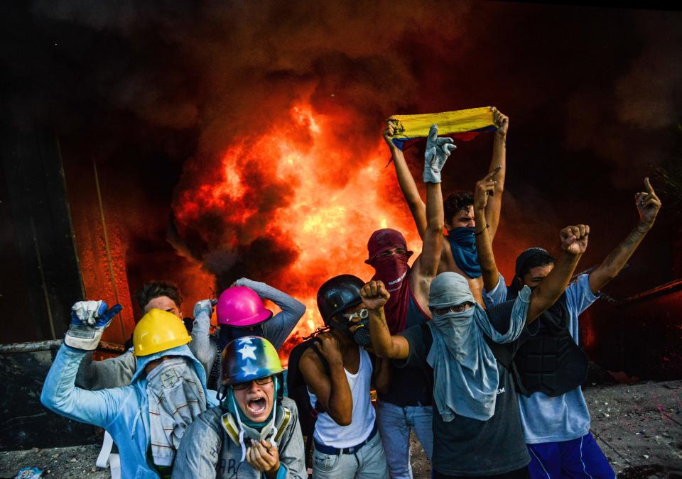 Anti-government demonstrators celebrate after an attack on the administration headquarters of Venezuela's Supreme Court of Justice on June 12.