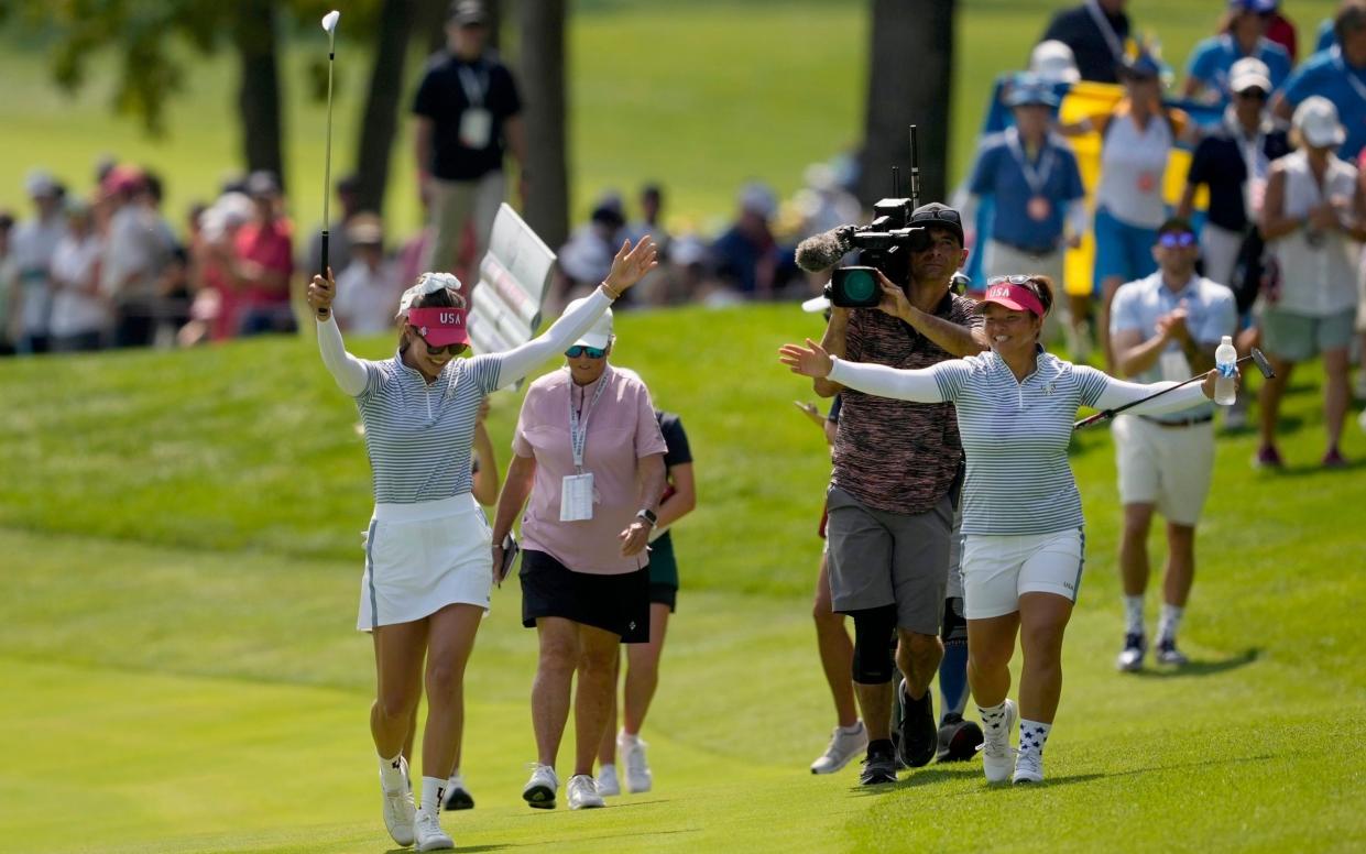 United States' Alison Lee, left, celebrates after finding the cup from the fairway on the second hole