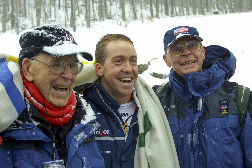 FILE - In this Dec. 20, 2001, file photo, Jim Shea, center, stands with his father, Jim Shea, Sr., right, and grandfather, Jack Shea, left, after Shea placed second in the World Cup Skeleton men's competition in Lake Placid, N.Y. With the finish, Shea earned a spot on the U.S. Olympic team and made his family the first to produce three generations of American Olympians. Jack Shea, 91, won two speedskating gold medals at the 1932 Olympics in Lake Placid. Jim Shea Jr. represented the United States at the 1964 Winter Games in Innsbruck in three skiing events. Lake Placid is celebrating the 40th anniversary of the Winter Olympics that were held in the Adirondack Mountain village. (AP Photo/ Jim McKnight)