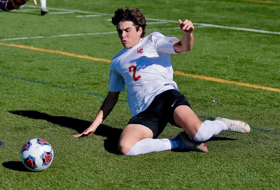 Worthington Christian's Cam Broadfoot slides to gain control of a loose ball in a Division III regional final against Cincinnati Madeira on Nov. 6 at Bellbrook. The Warriors lost 3-0.