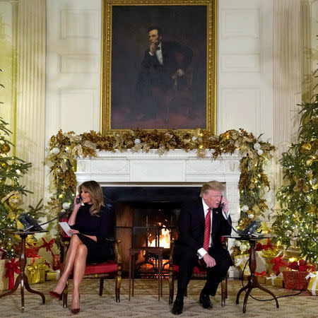 FILE PHOTO: U.S. President Donald Trump and first lady Melania Trump participate in NORAD Santa tracker phone calls from the White House in Washington, Dec. 24, 2018. REUTERS/Jonathan Ernst/File Photo